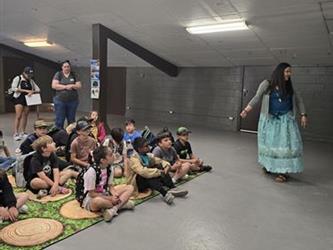 Students learning from the native american cultural group