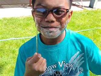 A student pretending to learn to shave