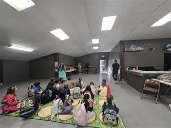 Students learning from the Native American cultural group