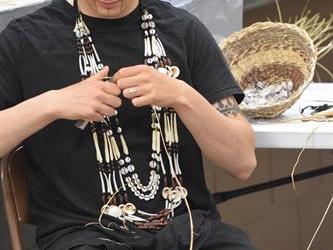 One of the members from the native american cultural committee working on beawork.